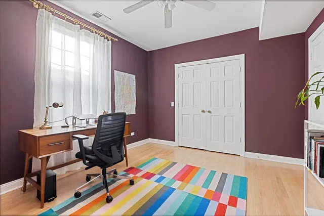 a view of a workspace with furniture and a window