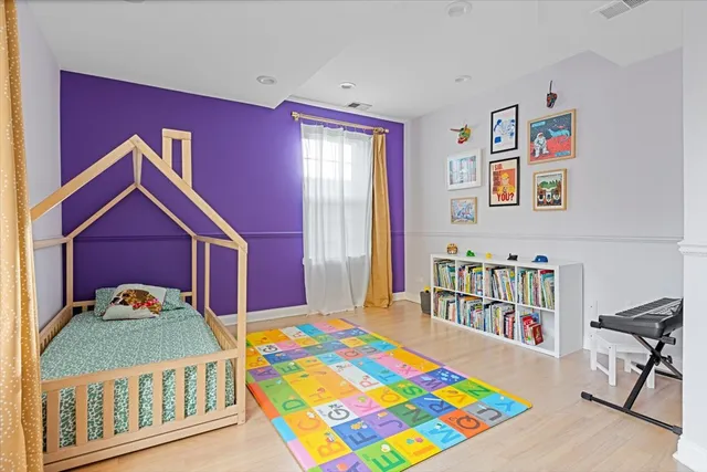 a bedroom with a bed and a dresser in it