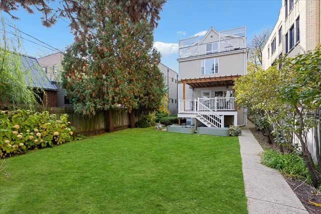 a view of a house with a yard and sitting area