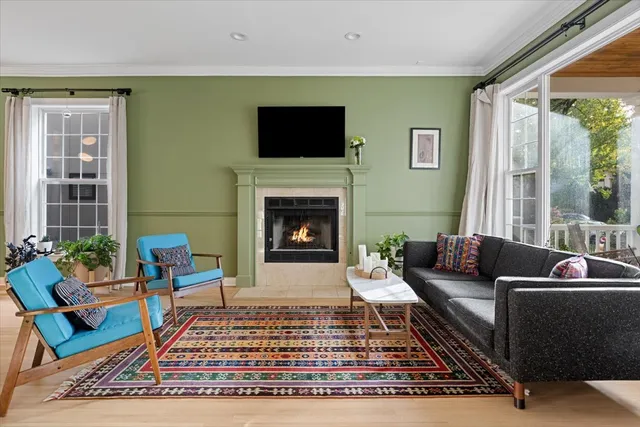 a living room with furniture a rug and a fireplace