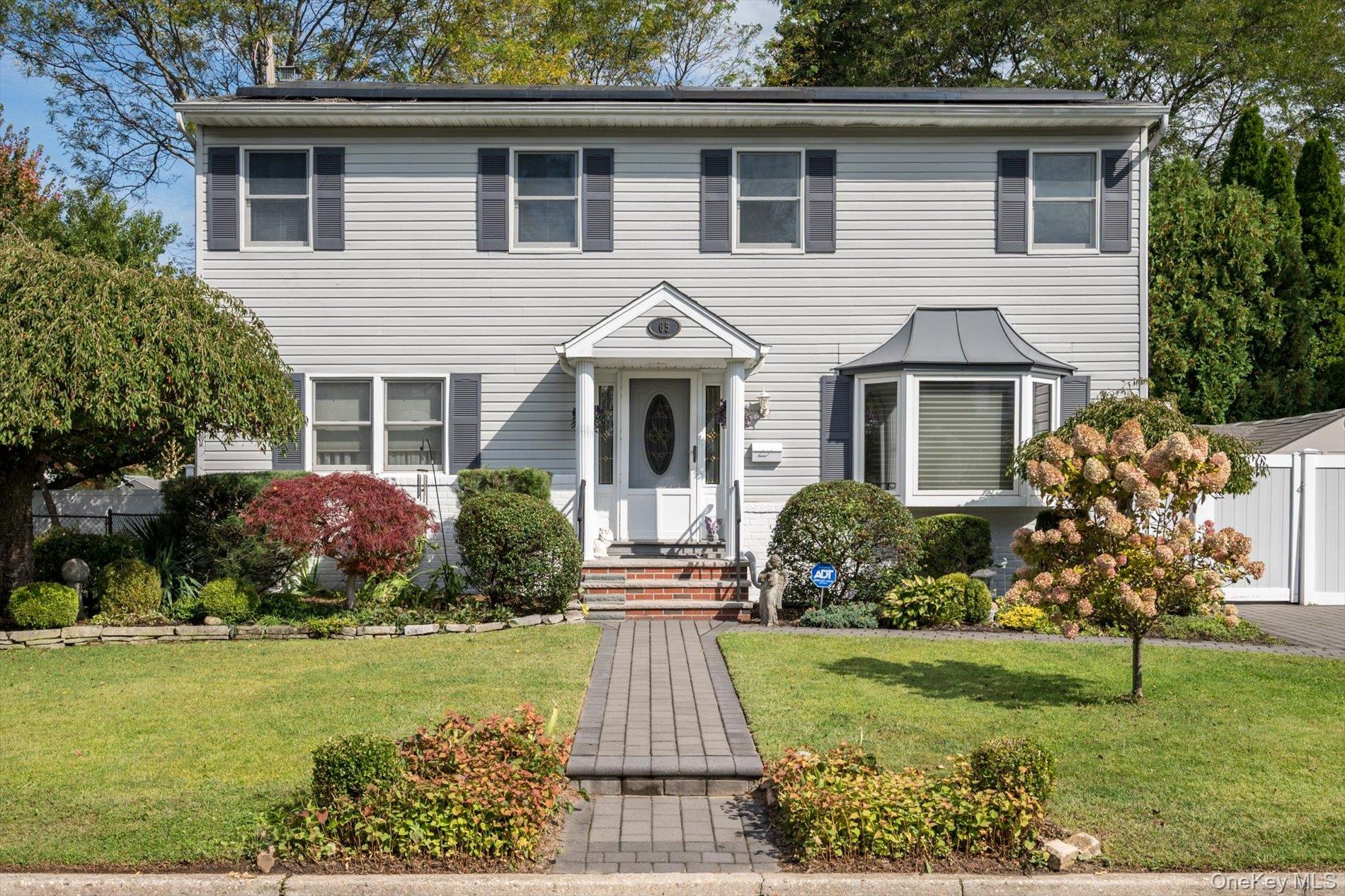 View of front of house with a front lawn and an outdoor structure