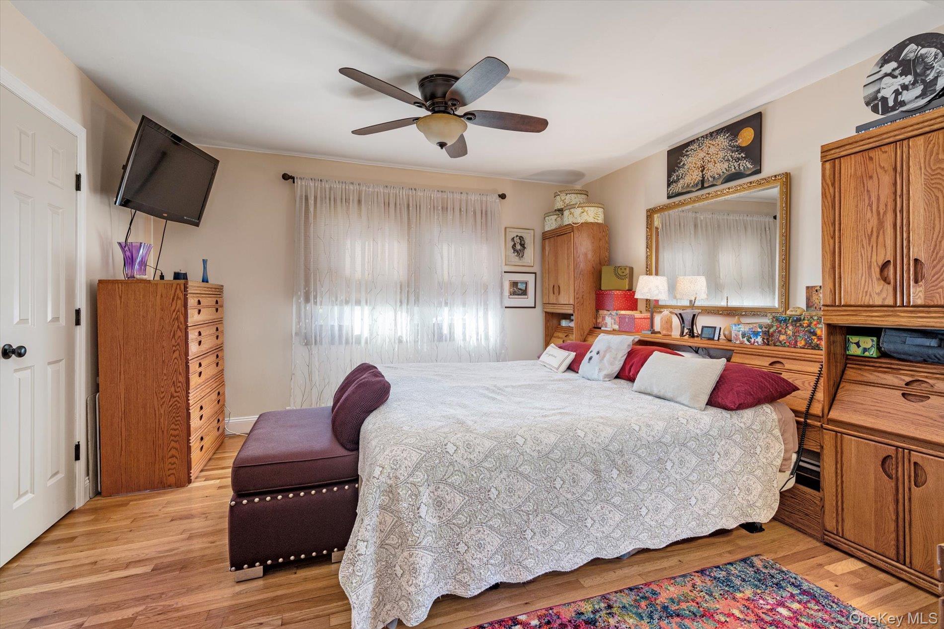 65 Harriet Road North Babylon, NY 11703 - Photo 13 of 31 Bedroom with light wood-type flooring and ceiling fan