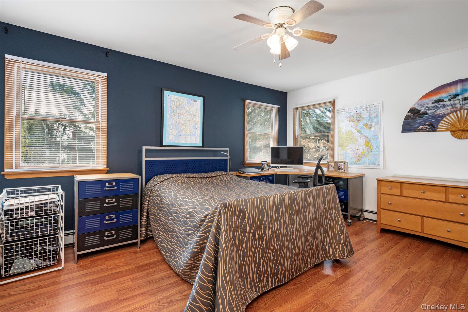 65 Harriet Road North Babylon, NY 11703 - Photo 20 of 31 Bedroom with light wood-type flooring, ceiling fan, and a desk