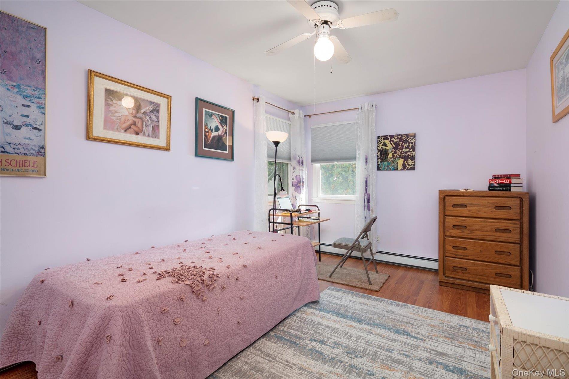 65 Harriet Road North Babylon, NY 11703 - Photo 21 of 31 Bedroom with wood finished floors, a ceiling fan, and a baseboard radiator