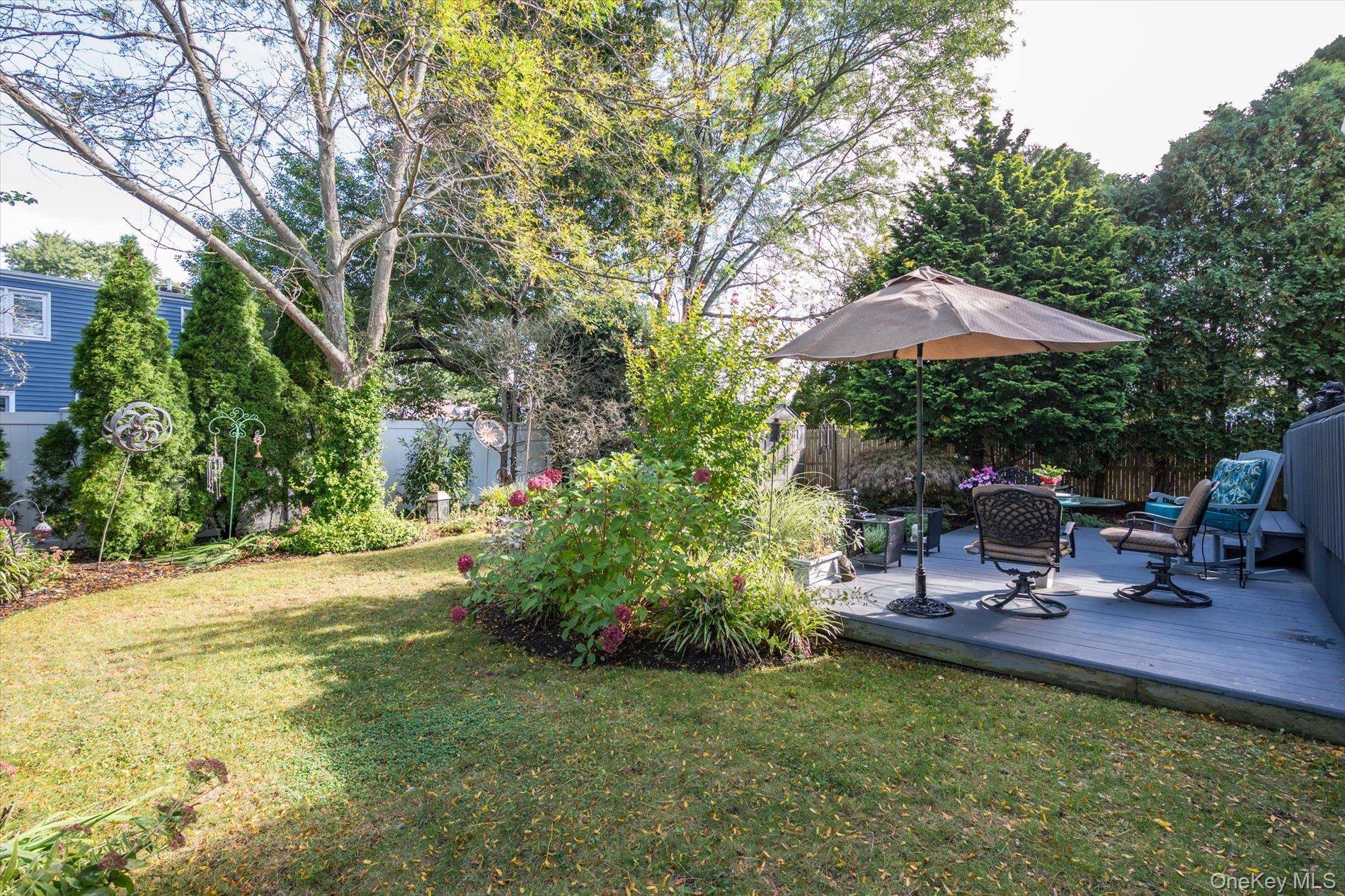 65 Harriet Road North Babylon, NY 11703 - Photo 28 of 31 Fenced backyard with a deck