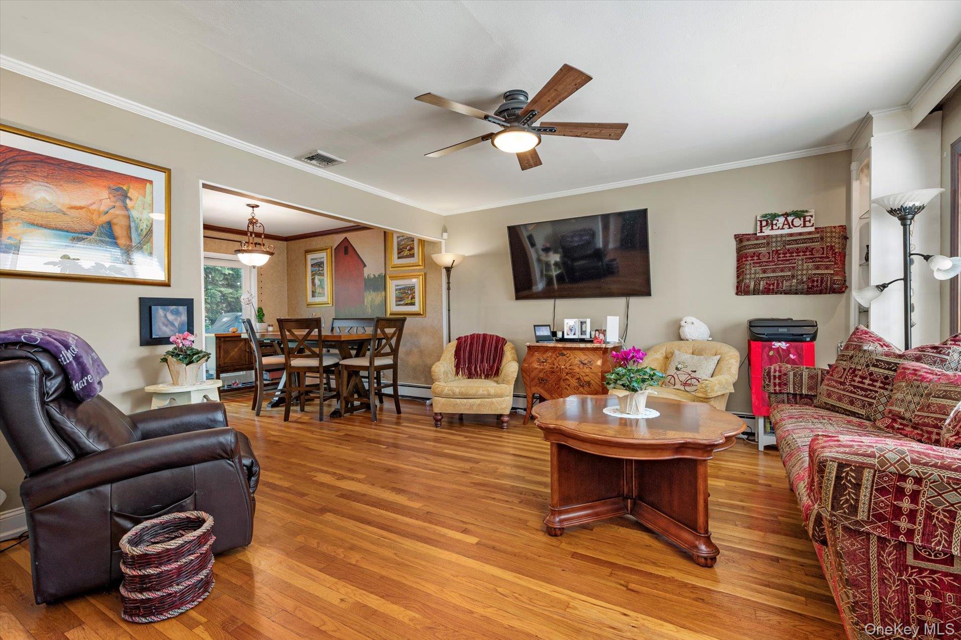 65 Harriet Road North Babylon, NY 11703 - Photo 4 of 31 Living area featuring crown molding, light wood-style flooring, and ceiling fan