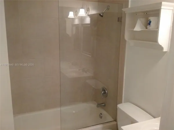 a bathroom with a shower and a toilet