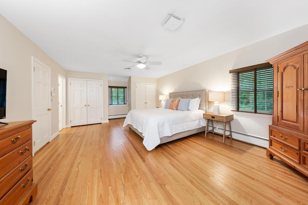 78 Stanton Road Darien, CT 06820 - Photo 19 of 33 a bedroom with a bed and a flat tv screen on dresser