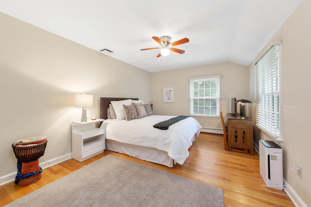 78 Stanton Road Darien, CT 06820 - Photo 22 of 33 a bedroom with a bed and wooden floor