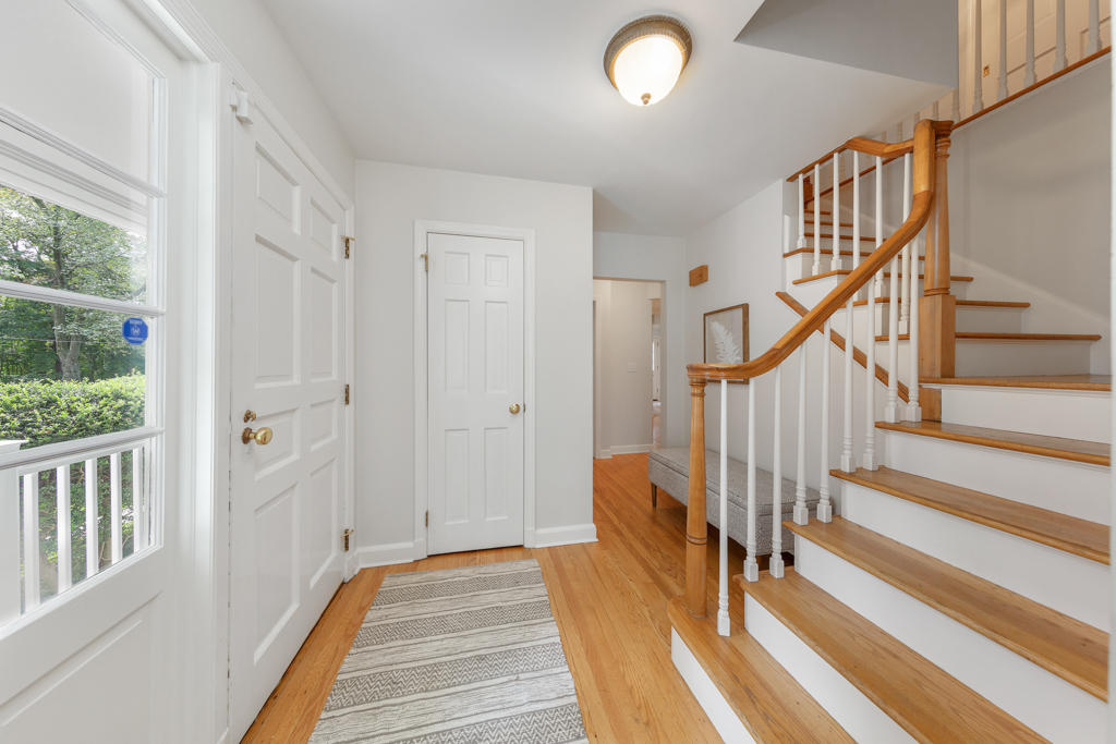 78 Stanton Road Darien, CT 06820 - Photo 3 of 33 a view of a hallway with wooden floor and staircase