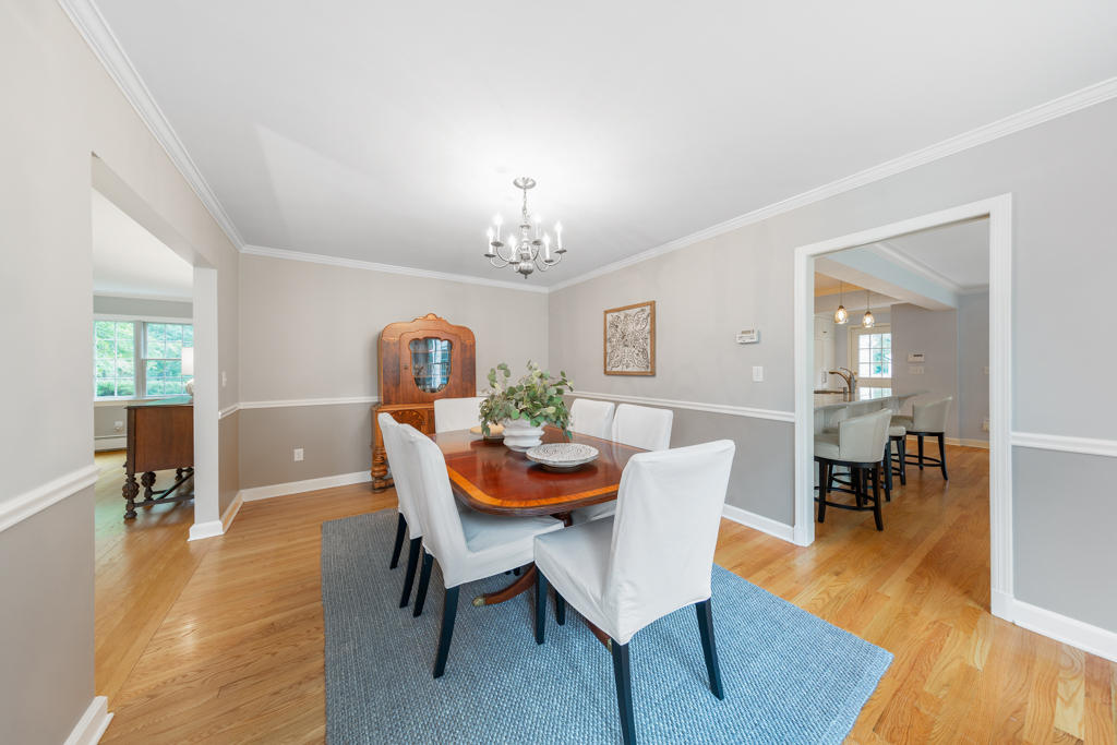 78 Stanton Road Darien, CT 06820 - Photo 7 of 33 a dining room with furniture wooden floor a rug and a chandelier