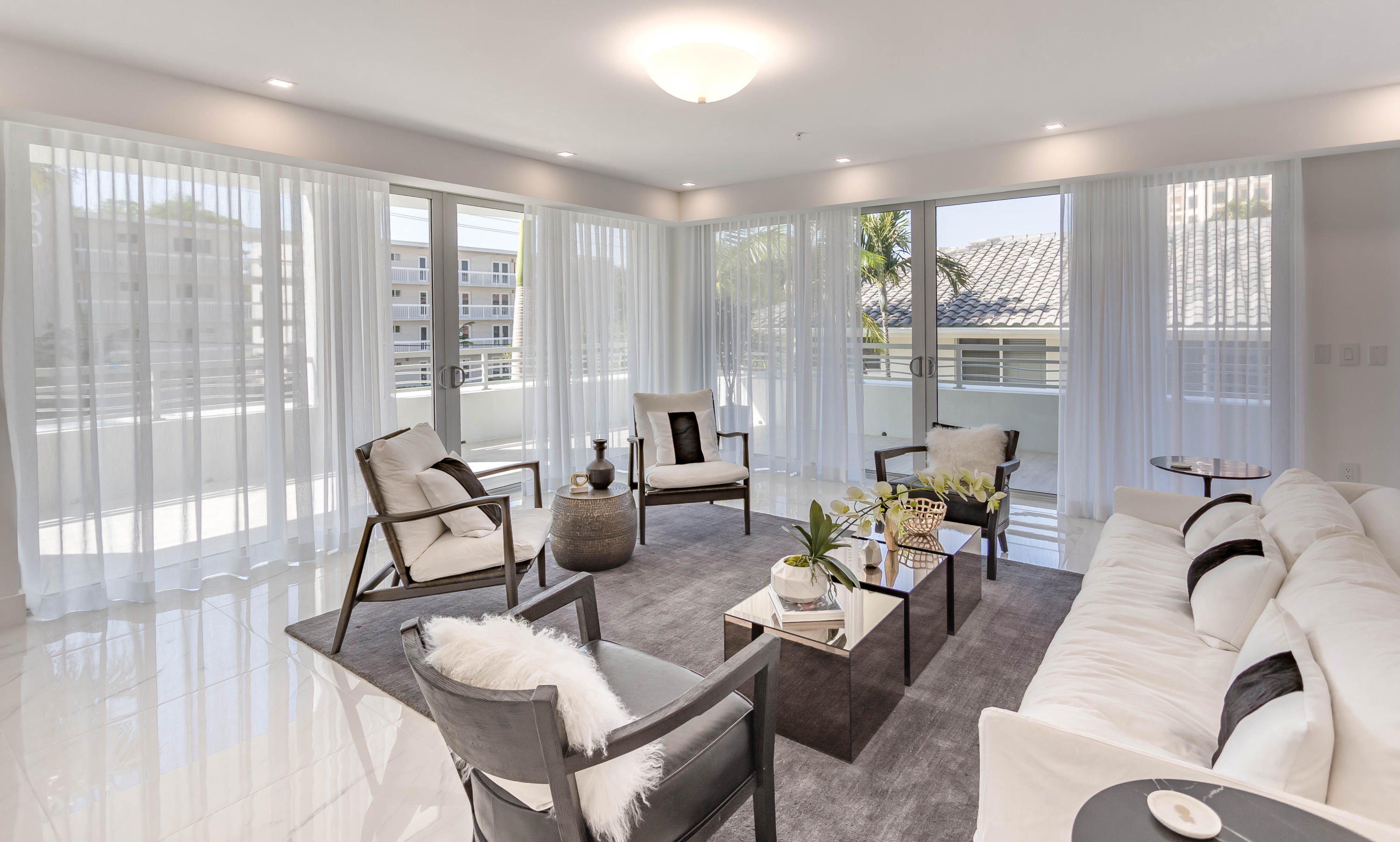 327 East Royal Palm Road, Unit 203 Boca Raton, FL 33432 - Photo 24 of 46 a living room with furniture and floor to ceiling windows