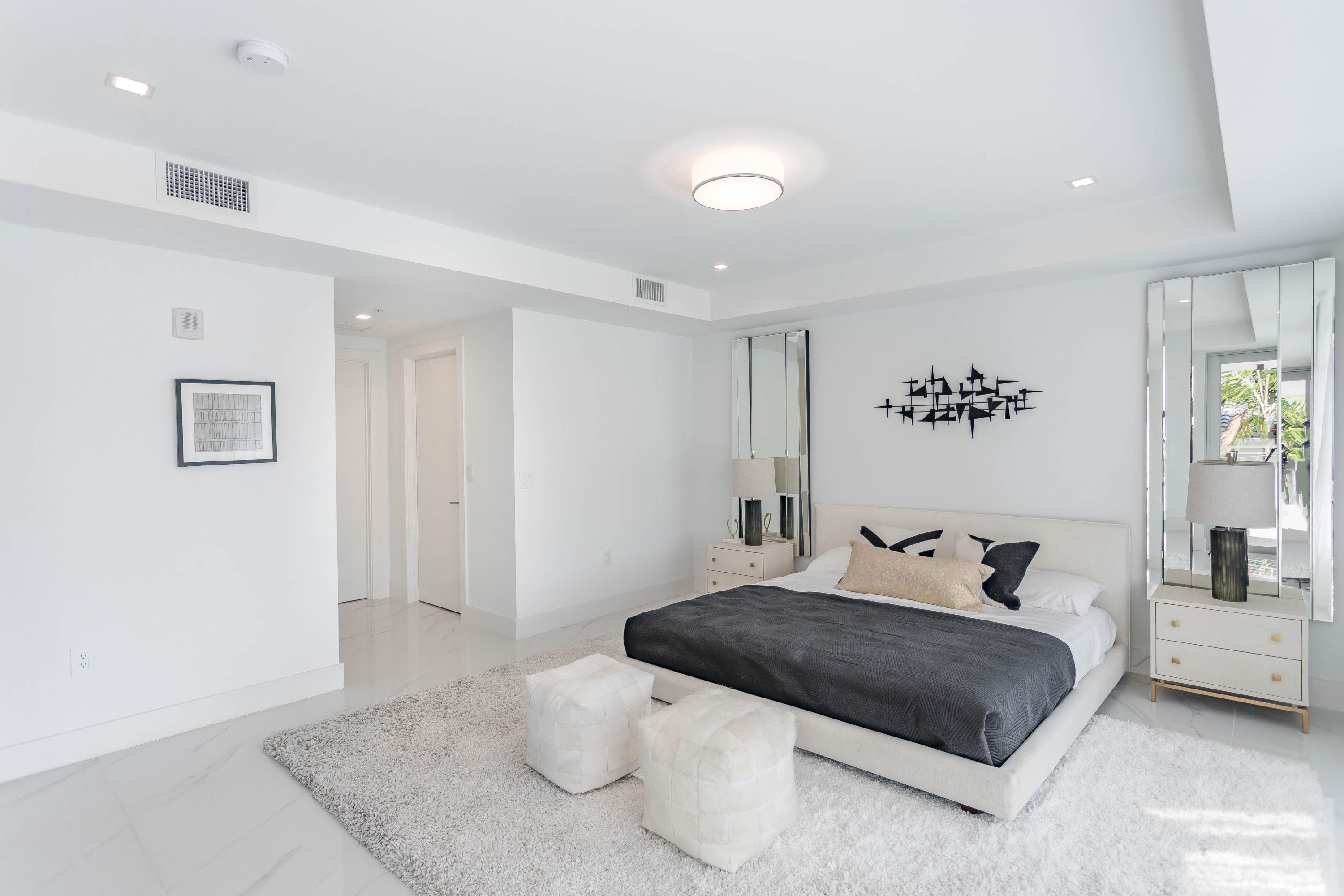 327 East Royal Palm Road, Unit 203 Boca Raton, FL 33432 - Photo 26 of 46 a bedroom with a large bed and a couch