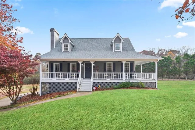 a front view of house with yard and green space