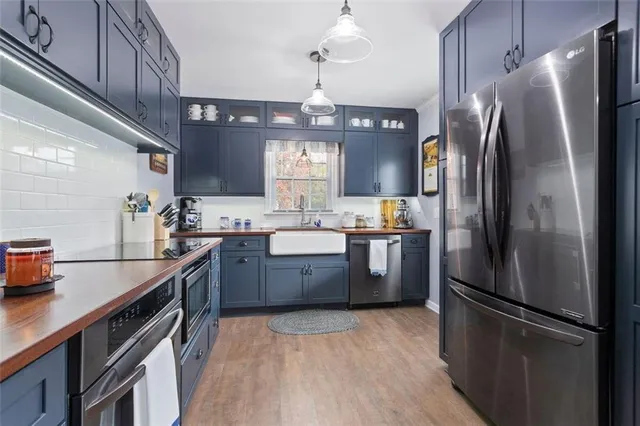 a bedroom with a bed and dresser with mirror