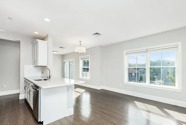 a kitchen with granite countertop a sink and cabinets