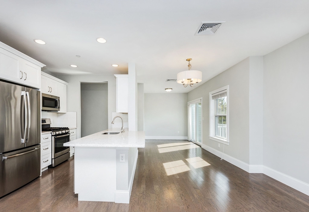 445 Essex Street, Unit 304 Swampscott, MA 01907 - Photo 13 of 35 a large kitchen with a sink a refrigerator and a stove