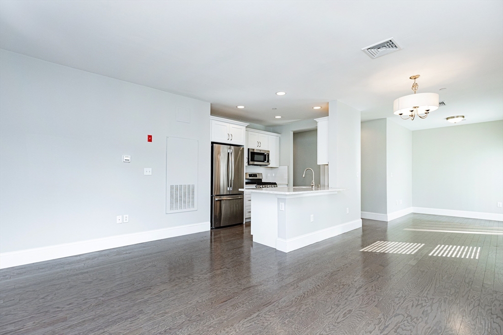 445 Essex Street, Unit 304 Swampscott, MA 01907 - Photo 6 of 35 a view of kitchen with refrigerator and window