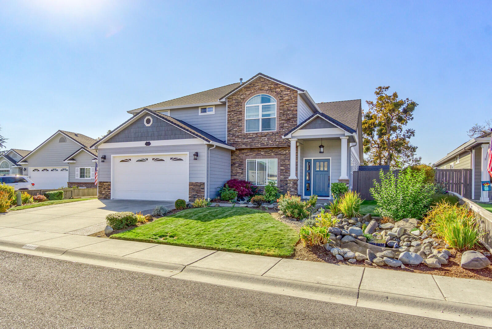 331 Ridgeway Avenue Central Point, OR 97502 - Photo 2 of 47 a front view of a house with a yard and a garage