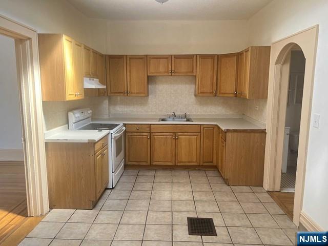 212 Main Street Ridgefield Park, NJ 07660 - Photo 2 of 12 a kitchen with a stove a sink dishwasher and a refrigerator