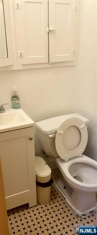 212 Main Street Ridgefield Park, NJ 07660 - Photo 8 of 12 a bathroom with a toilet a sink and a window