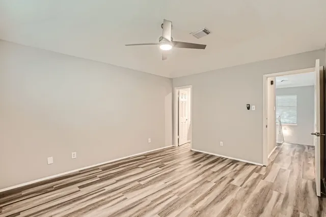 wooden floor in an empty room with a window
