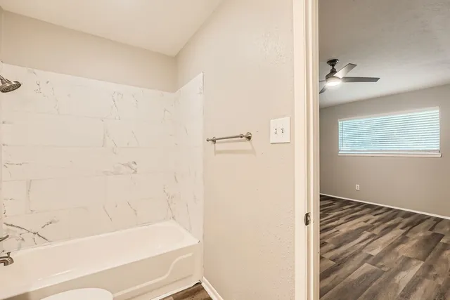 a bathroom with a bathtub and a shower