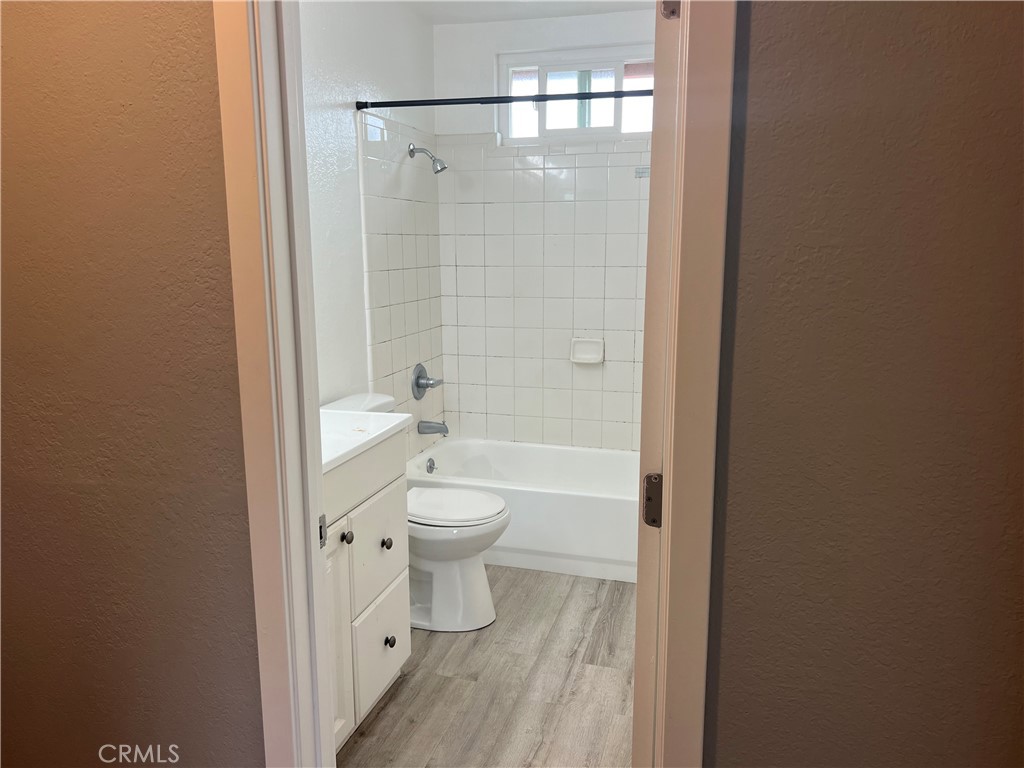 136 West 53rd Street, Unit A Long Beach, CA 90805 - Photo 11 of 13 a bathroom with a toilet and a shower