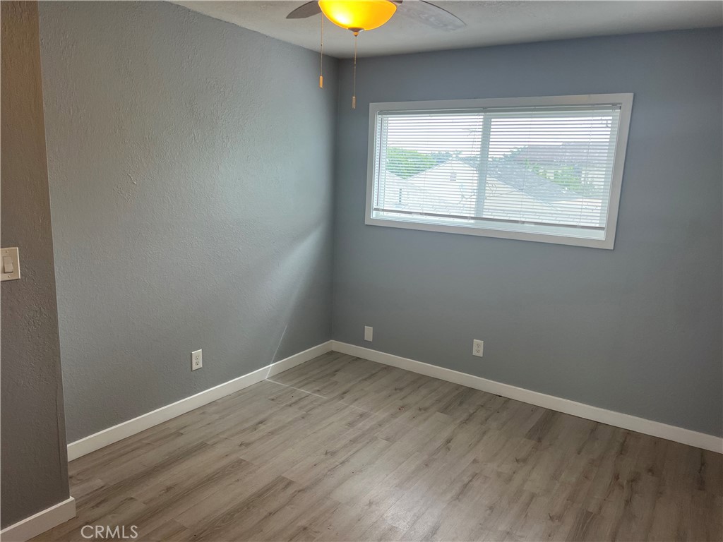 136 West 53rd Street, Unit A Long Beach, CA 90805 - Photo 12 of 13 an empty room with wooden floor and windows