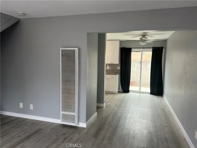 a view of a hallway with wooden floors