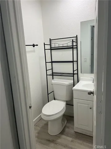 a white toilet sitting next to a sink