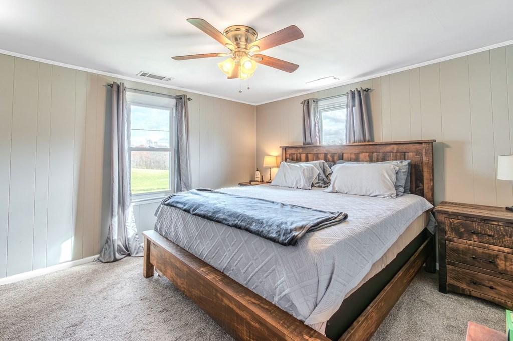 9340 Old Highway 76 Morganton, GA 30560 - Photo 13 of 19 a bedroom with a bed and a chandelier