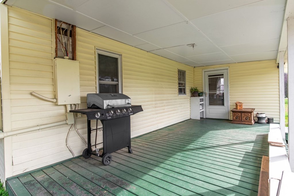9340 Old Highway 76 Morganton, GA 30560 - Photo 19 of 19 a view of a patio with table and chairs with wooden floor and fence
