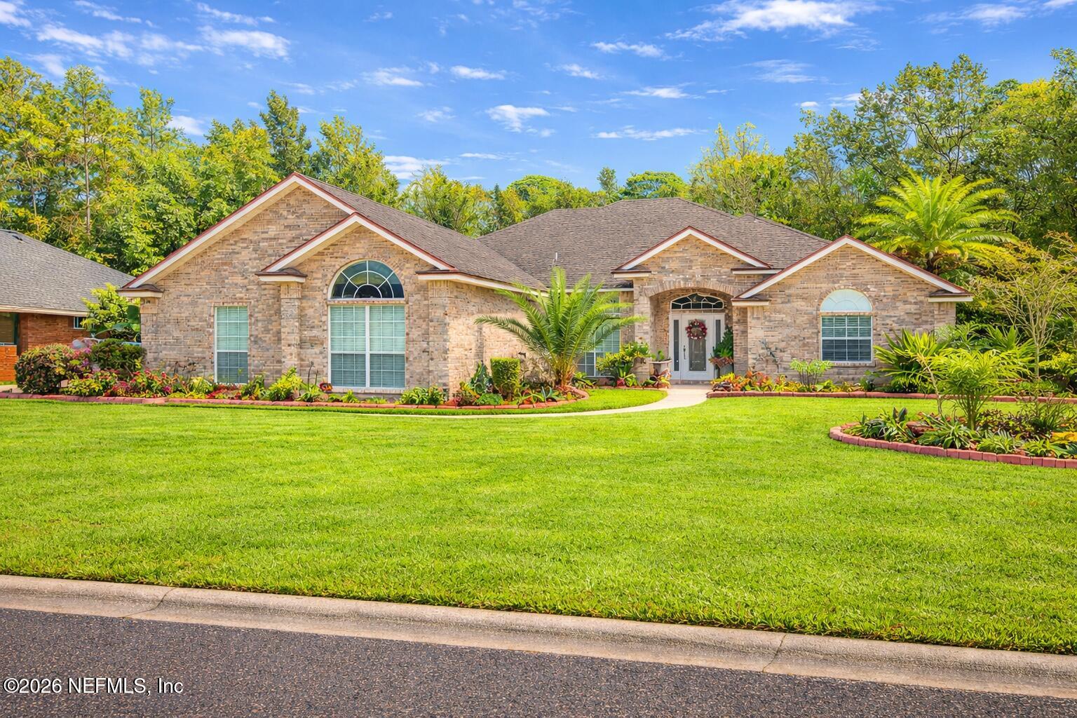 a front view of a house with a garden