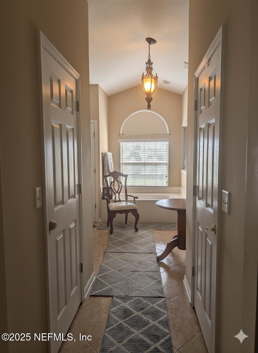 1539 Lockend Court Jacksonville, FL 32221 - Photo 16 of 23 a living room with furniture and a chandelier