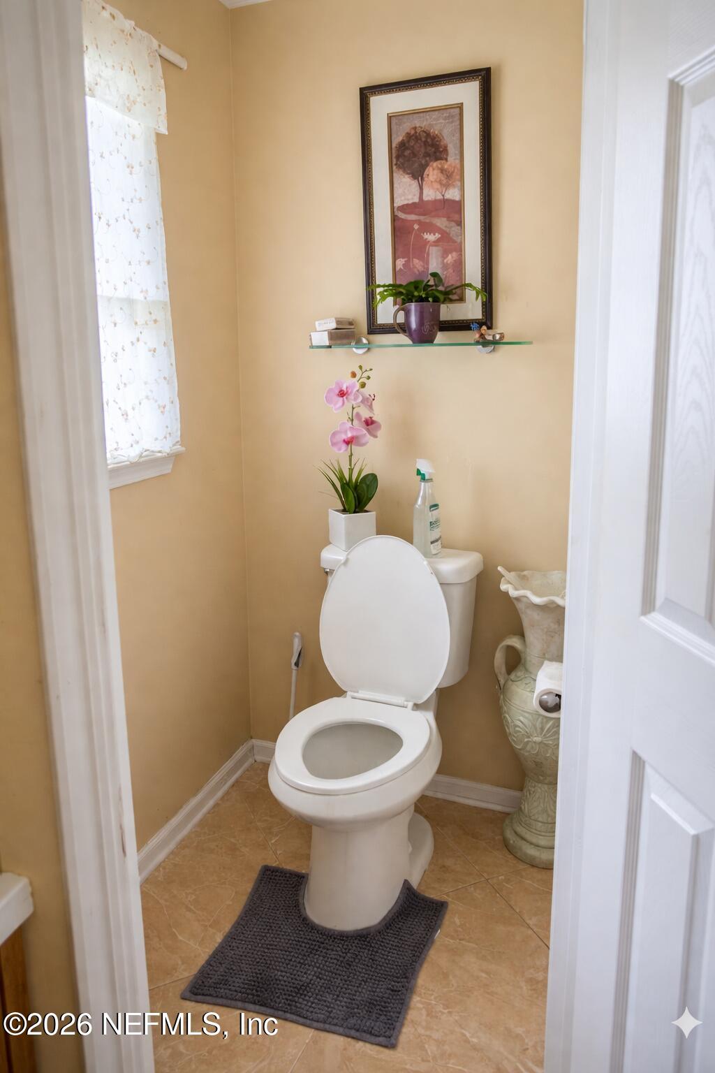 1539 Lockend Court Jacksonville, FL 32221 - Photo 19 of 24 a bathroom with a toilet and a painting on the wall