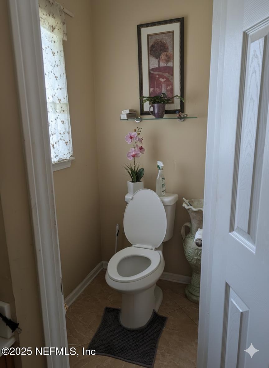 1539 Lockend Court Jacksonville, FL 32221 - Photo 20 of 23 a white toilet sitting next to a small bathroom