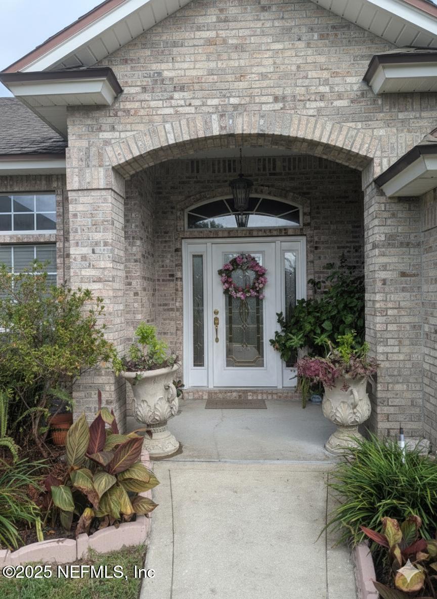 1539 Lockend Court Jacksonville, FL 32221 - Photo 2 of 23 a front view of a house with potted plants