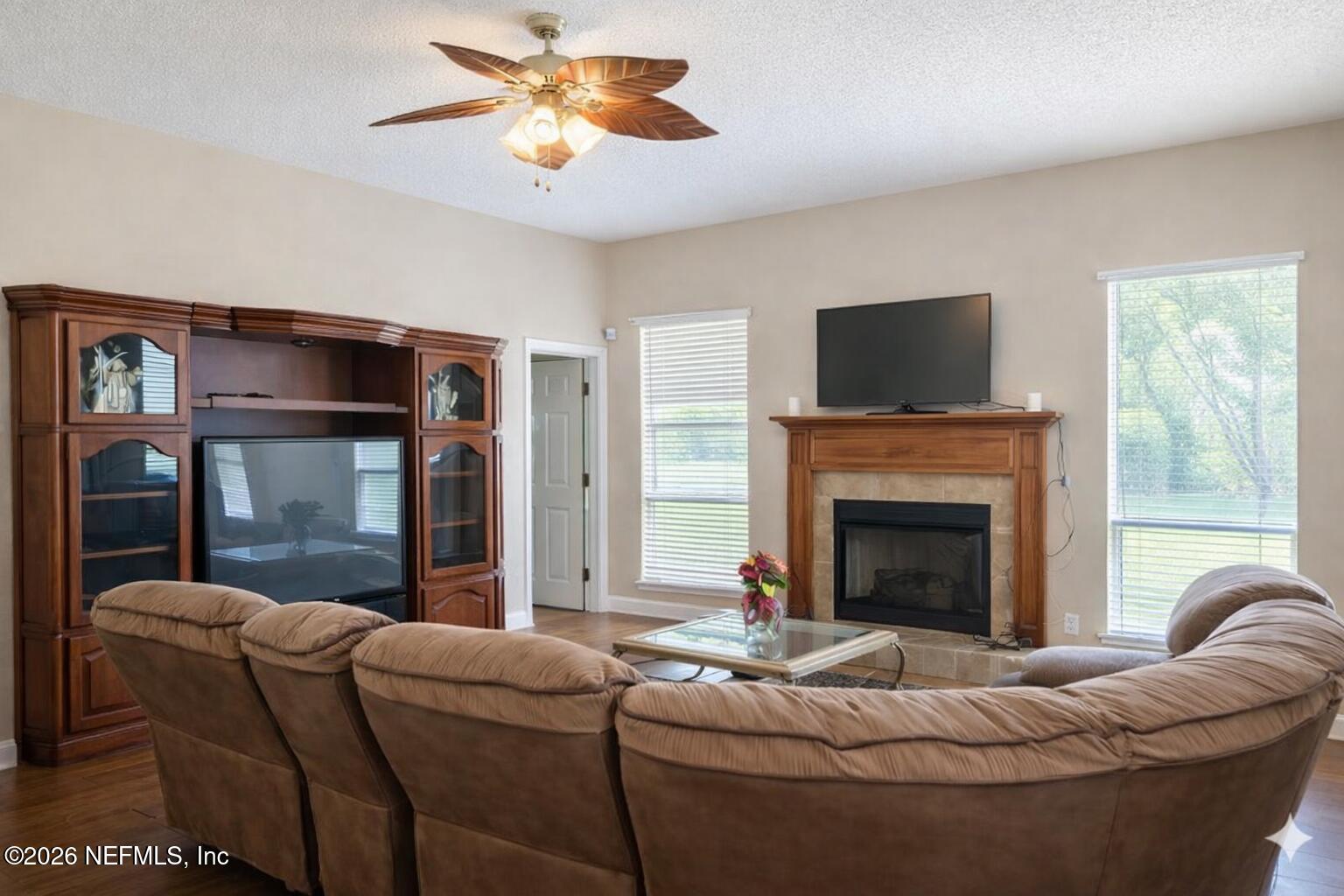 1539 Lockend Court Jacksonville, FL 32221 - Photo 9 of 24 a living room with furniture a flat screen tv and a fireplace