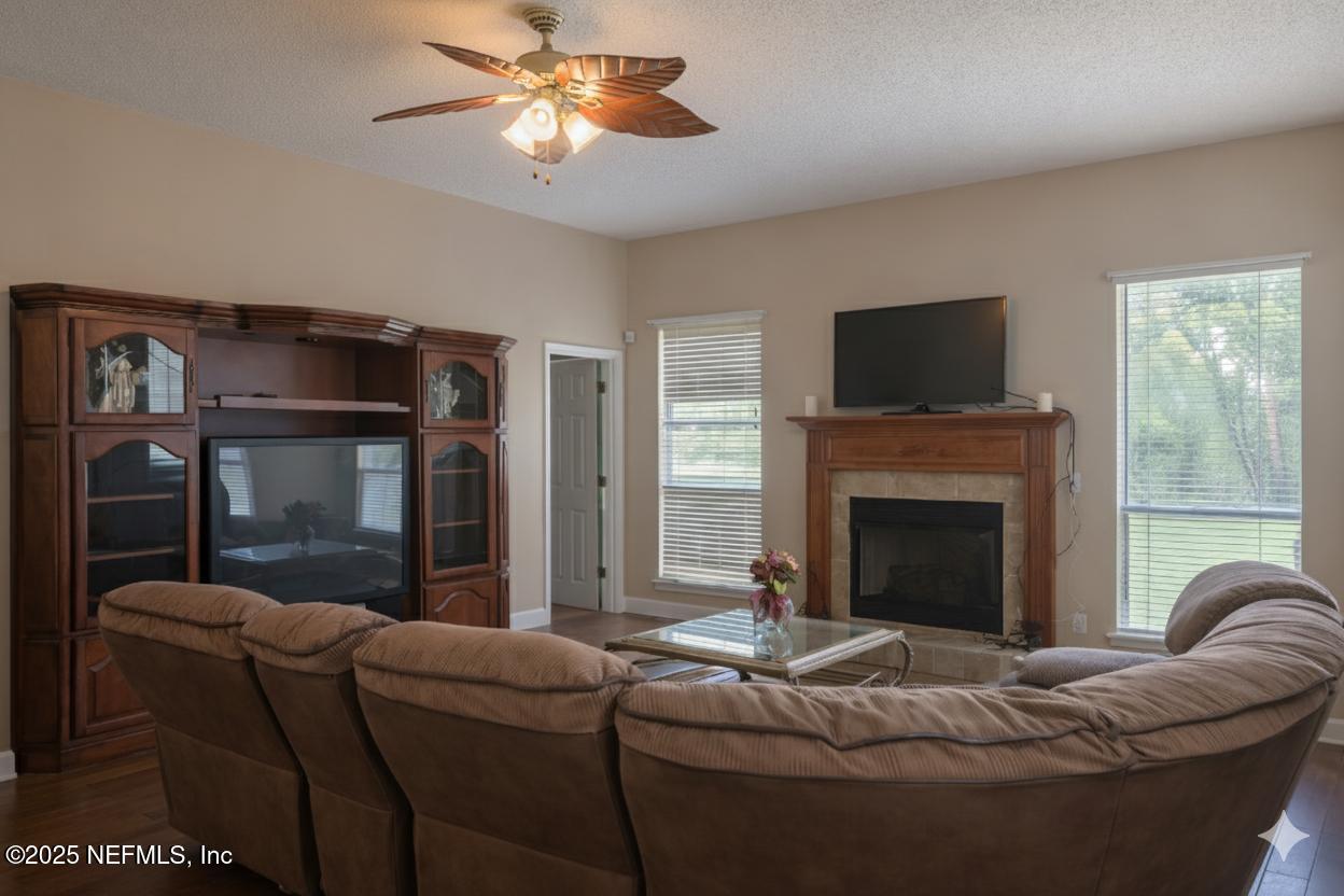 1539 Lockend Court Jacksonville, FL 32221 - Photo 9 of 23 a living room with furniture a flat screen tv and a fireplace