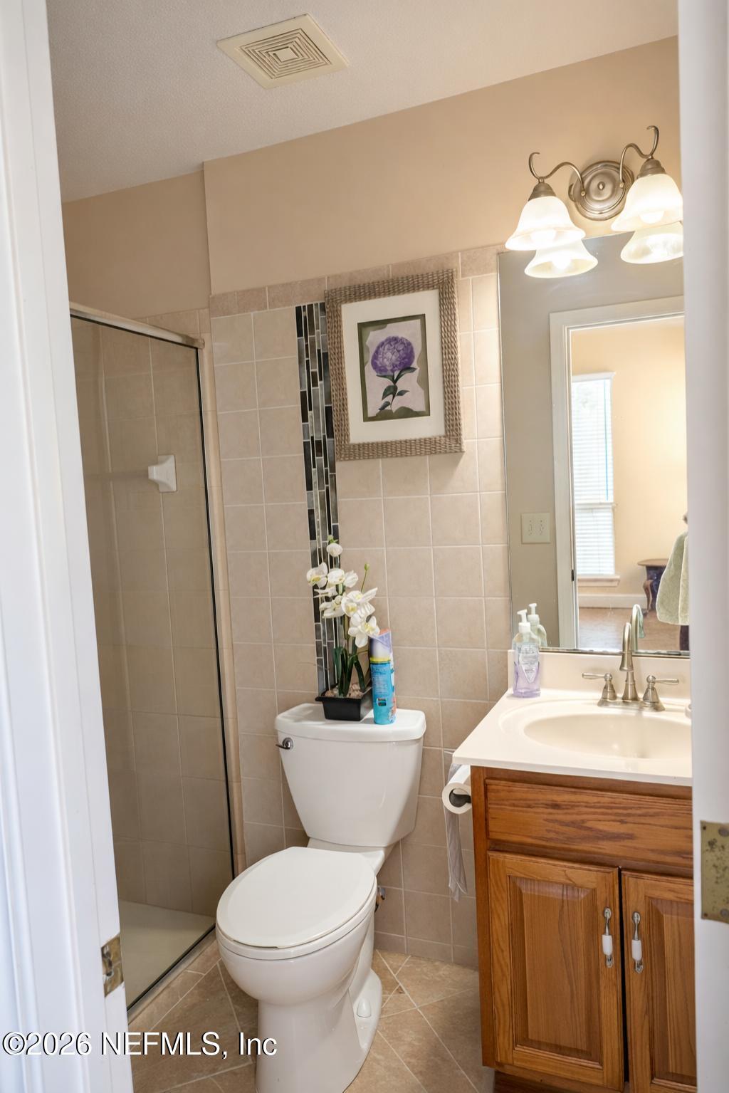 1539 Lockend Court Jacksonville, FL 32221 - Photo 10 of 24 a bathroom with a sink a mirror a toilet and shower
