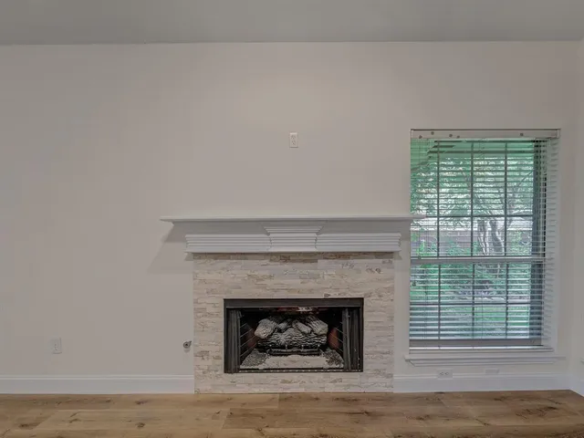 a living room with a fireplace and a fireplace