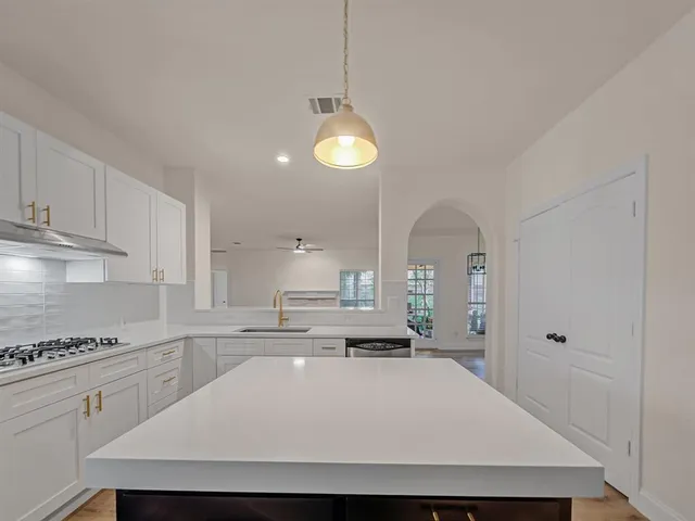 a view of a kitchen with a stove cabinets and a wooden floor