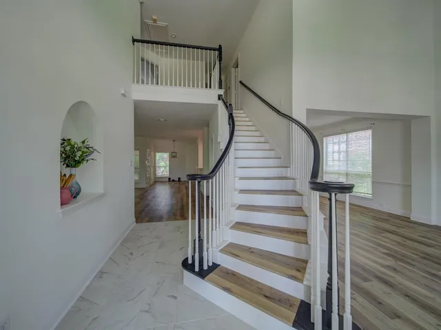 a view of entryway with wooden floor and front door