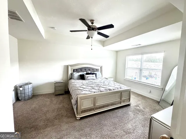 a bedroom with a bed and window