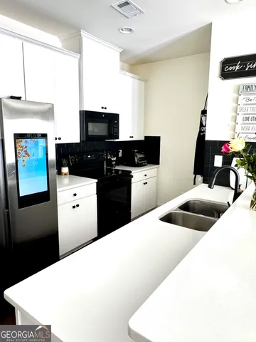 a kitchen with a sink a stove and refrigerator