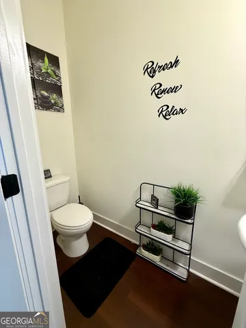 a bathroom with a toilet and a mirror