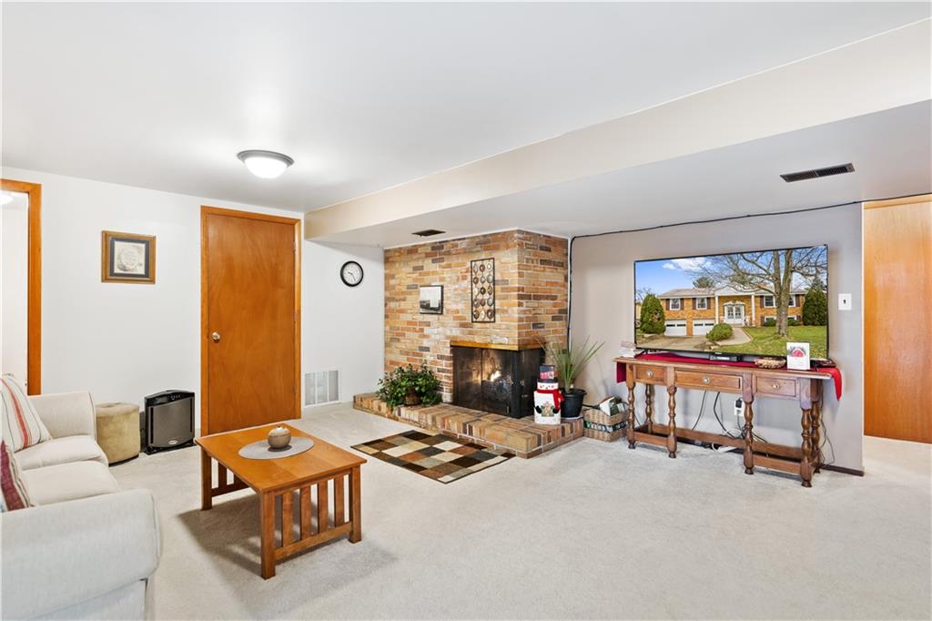 207 Lytton Road Coraopolis, PA 15108 - Photo 20 of 25 a living room with furniture a flat screen tv and a fireplace