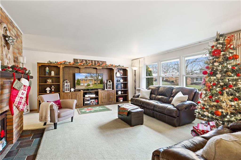 207 Lytton Road Coraopolis, PA 15108 - Photo 3 of 25 a living room with furniture a flat screen tv and a floor to ceiling window