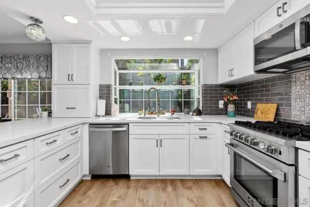 a kitchen with stainless steel appliances granite countertop a stove and a sink